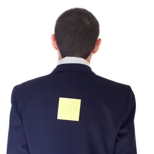 10 Best Team Building Activities For The Workplace Image of person with note on his back for Matched Pairs team building game.
