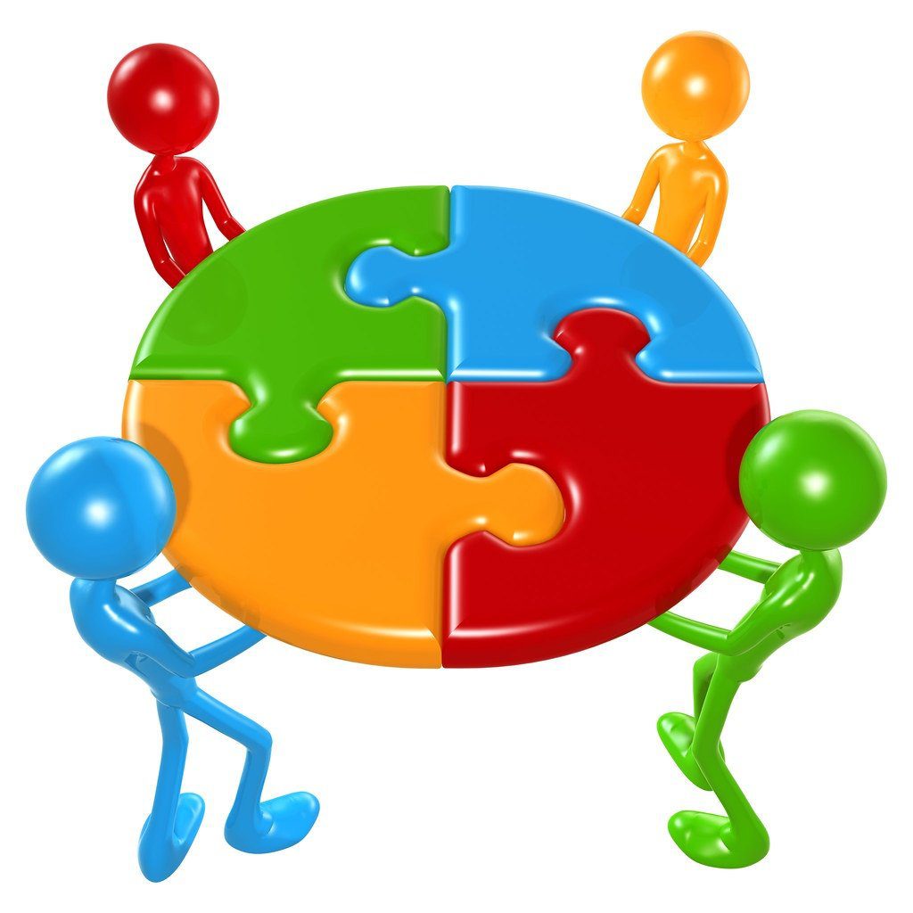 Team holding puzzle pieces representing the puzzle of team member roles.