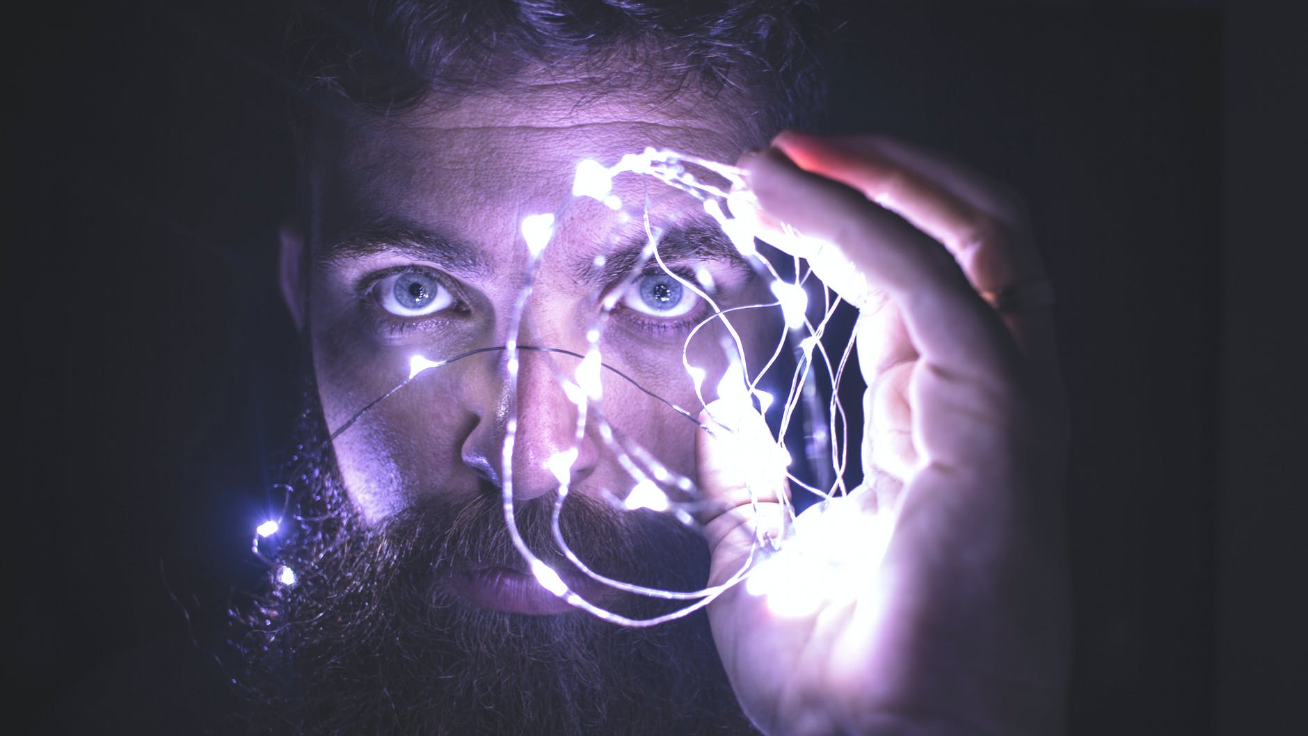 Team Performance: 15 Tips To Develop Superior Teams Image of a person holding string lights representing vision for team performance.