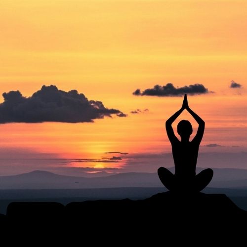 The Definitive Guide On How To Improve Problem Solving Skills Image a person doing yoga on the beach.