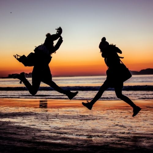 Image of 2 people jumping in joy