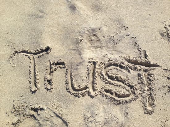 Image of trust written in the sand for the  how to delegate tip 1.