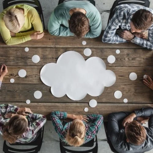 How to Run Effective Staff Meetings! 5 Easy Steps Image of people around a table in a meeting for steps for planning a meeting section.