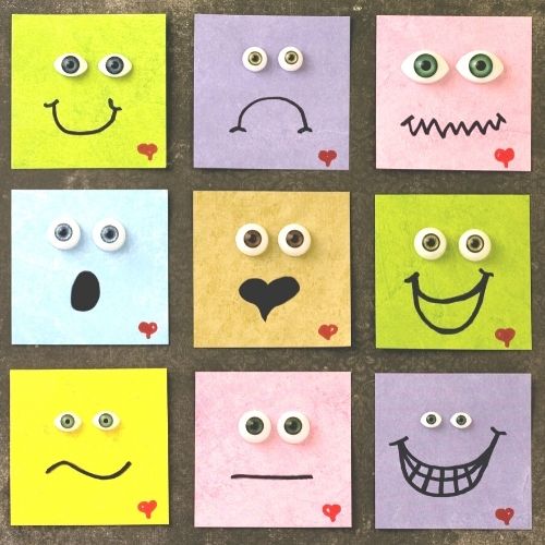 Image of sticky notes with different emotional faces drawn on them.