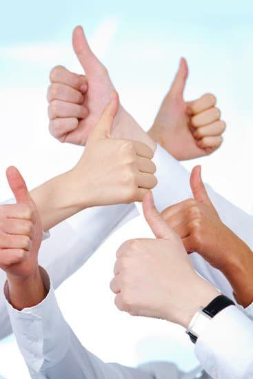 Image of many people giving thumbs up for positive mindset tip for teleworking.