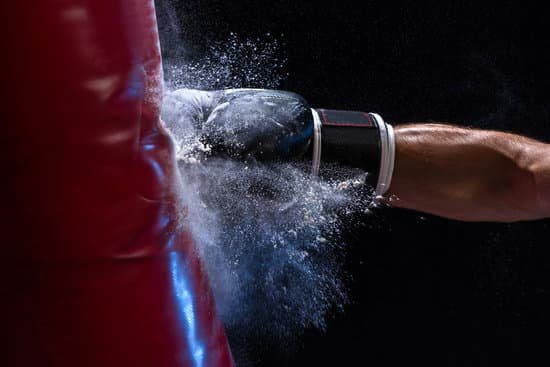 Image of a person kicking a punching bag representing strength for self-leadership.