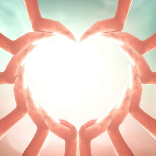 Image of hands creating a heart for the volunteer section.