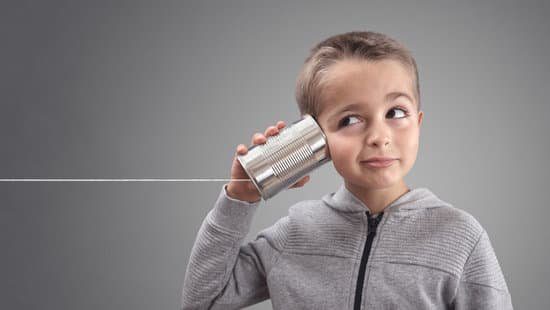 How to Be a Good Communicator (24 Powerful Tips) Image of a boy listening into a can attached to a string to represent listening to improve communication skills, master communication skills.