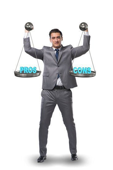 Image of  a man holding a scale with pros on one side and cons on the other for disadvantages of working from home.