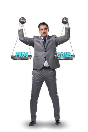 Image of a man holding a scale with pros on one side and cons on the other for disadvantages of working from home.