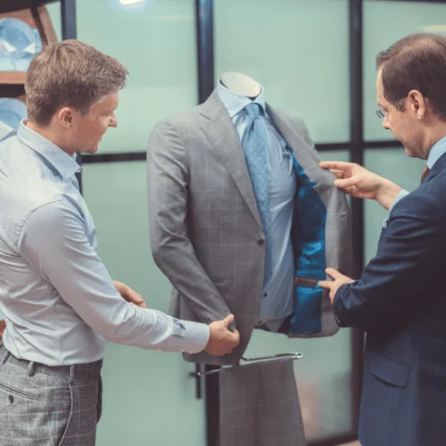 12 Tips for Creating a Professional Image at Work Image of two men looking at a suit for their professional image, personal image, image branding, personal branding.