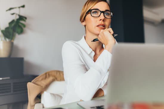 How To Write A Vision Statement That Will Inspire And Motivate Image of a woman thinking for the personal vision statement section.