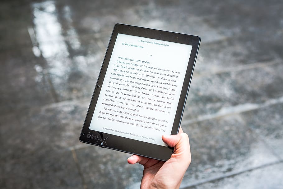 25 Free Personal and Professional Development Resources Image of a person reading an eBook for personal growth.