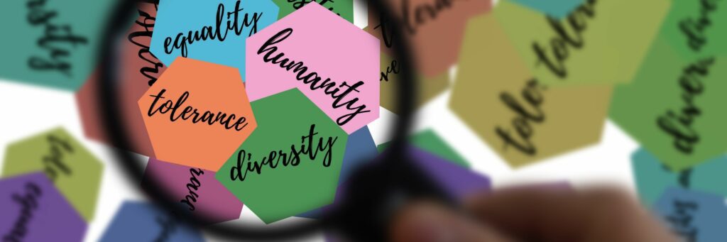 21 Expert Tips To Handle Disrespect In The Workplace Image of magnifying glass with the words diversity, tolerance, humanity, and equlity.