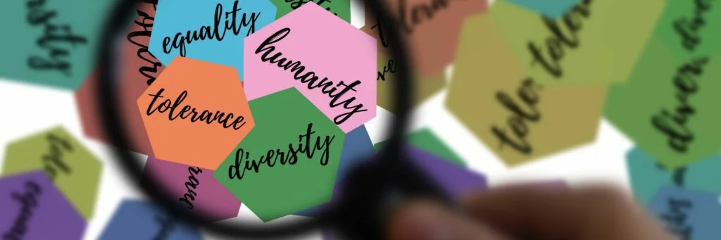 21 Expert Tips To Handle Disrespect In The Workplace Image of magnifying glass with the words diversity, tolerance, humanity, and equlity.