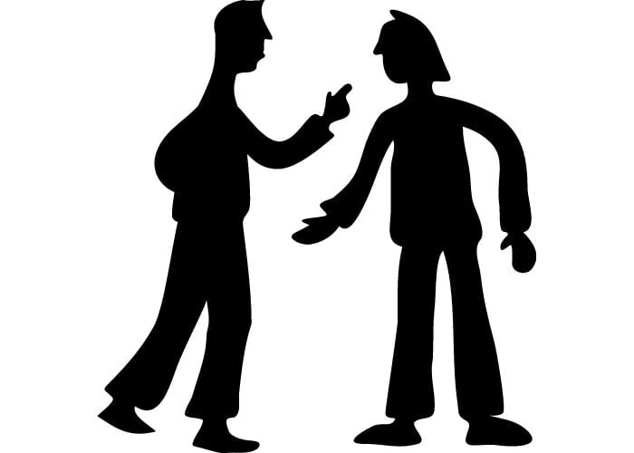 Silhouettes of two people in an argument. Characteristics of effective teams.