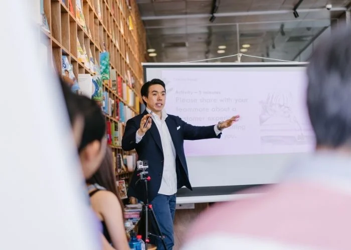 Afraid of Public Speaking? Implement These 25 Easy Tips Image of a man giving a public speech.