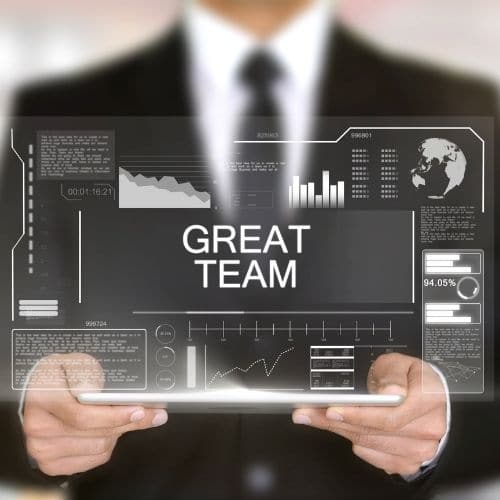 Image of business professional holding a tablet displaying great team for virtual team benefits.