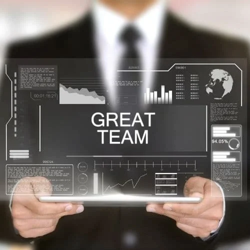 10 Fun Virtual Team Building Activities Employees Will Love Image of business professional holding a tablet displaying great team for virtual team benefits.
