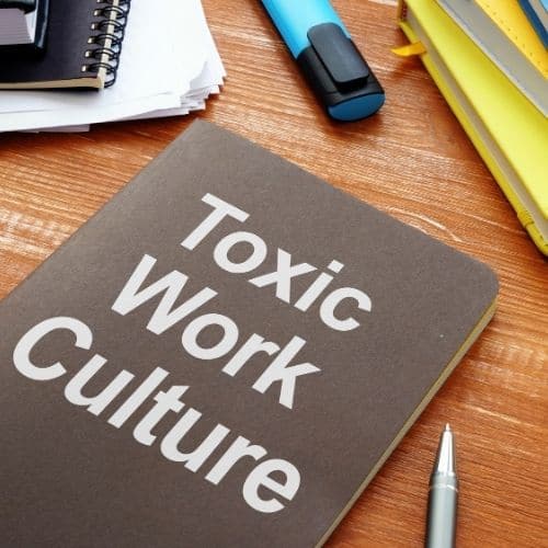 Image of a book with words toxic work culture for the toxic work environment causes section.