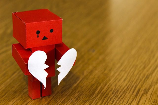 A robot holding a broken heart.