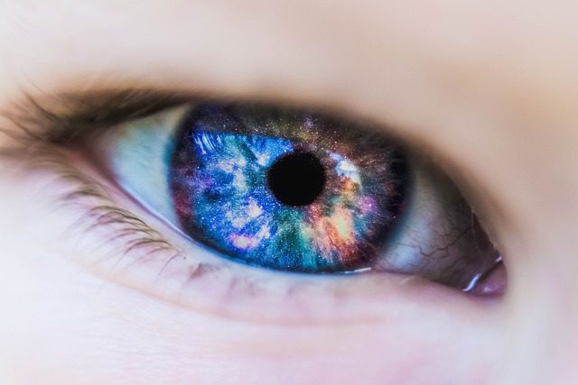Command Attention: What is Non-Verbal Communication? Close up of a eyeball with colors of the universe inside