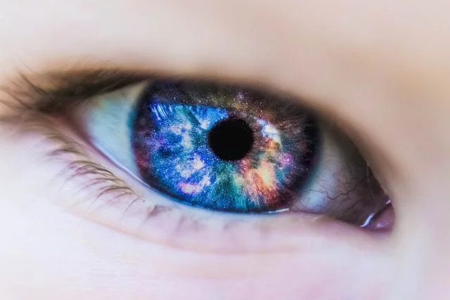 Command Attention: What is Non-Verbal Communication? Close up of a eyeball with colors of the universe inside