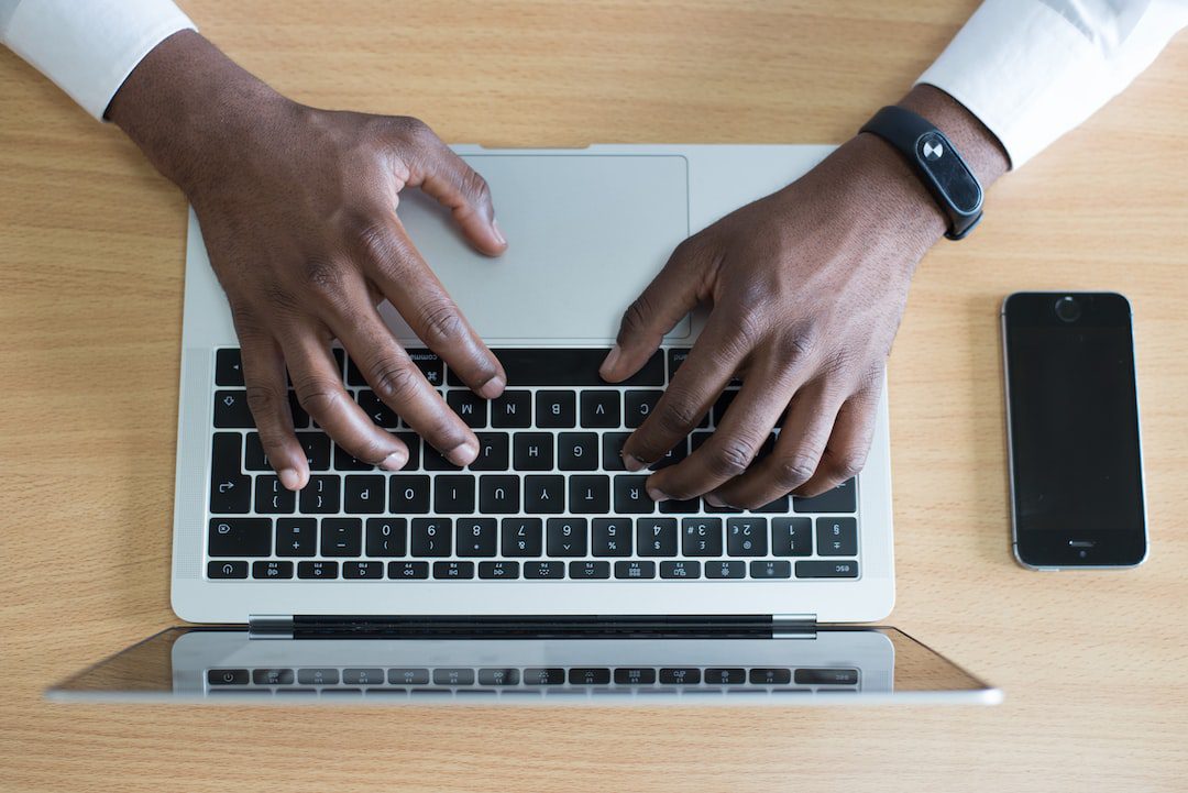 36 Crucial Tips for Improving Communication in the Workplace Person typing on a computer sending an email for technology related workplace communication.