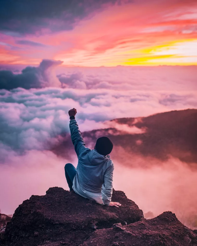 Charismatic Power and Authority for Awesome Leadership Man looking at beautiful sky and mountain ranges