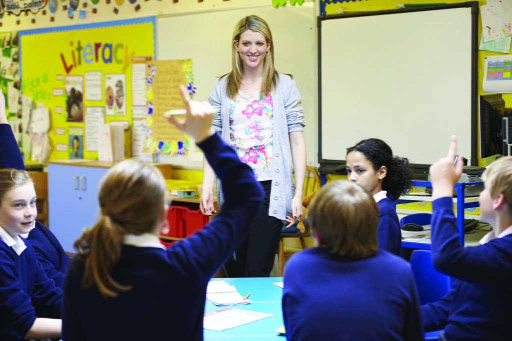 teacher instructing a class using the professional development topics.