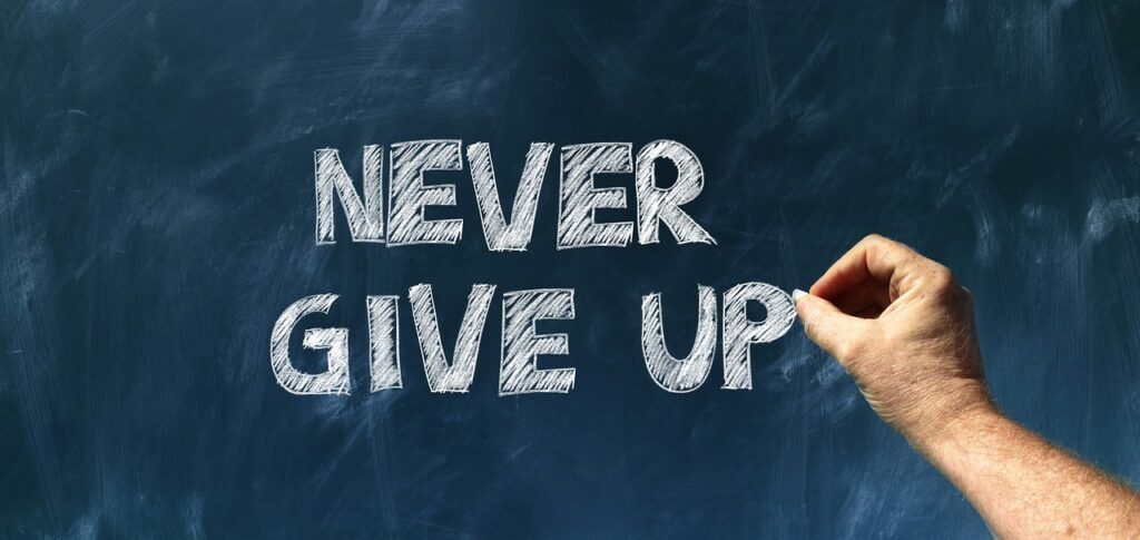 25 Crucial Keys To Success In Life You Can Start Now a chalk board with "Never Give Up" on it
