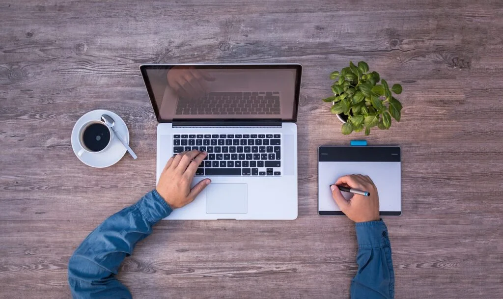Mastering the Rapid Planning Method (RPM) for Productivity person working on a laptop being productive.