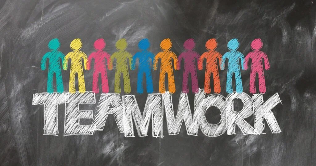 Building a Team from the Ground Up: Ultimate Guide colorful figures standing over the word teamwork
