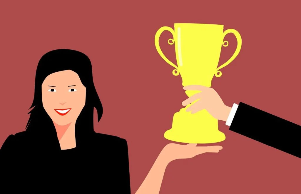 35 Team Rewards to Spark Morale and Success woman receiving a team reward.