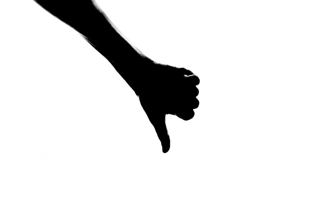 Dealing With a Negative Employee Before They Ruin the Team silhouette, thumb, down, negative attitude